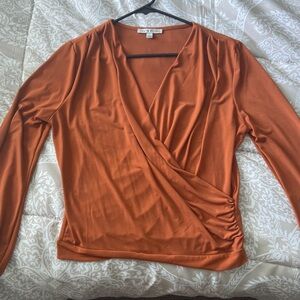 Cross over shirt. Orange color. Long sleeve. Size large. Gently worn.